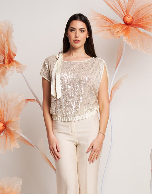 Casacca asimmetrica con paillettes e fiocco